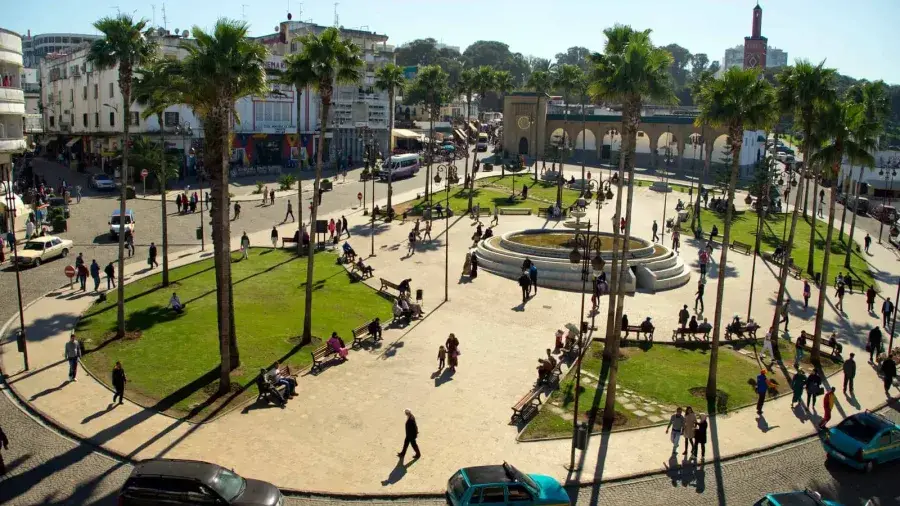 Palm trees, fountain and city life around Grand Socco in Tangier