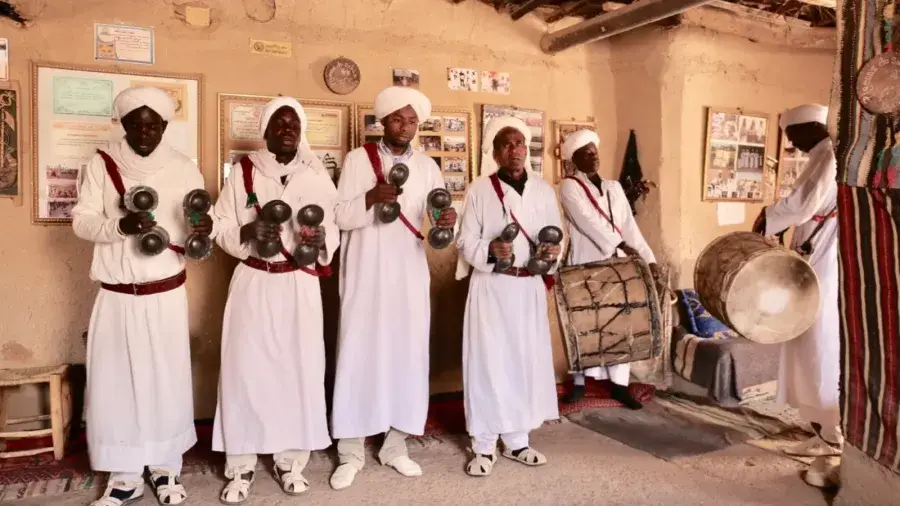 Gnawa ensemble performing with drums and qraqeb in Khamlia