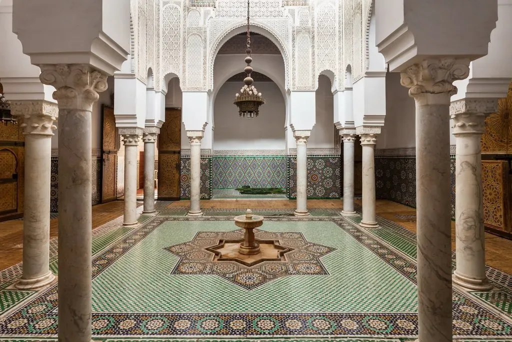 Traditional riad courtyard in Marrakech with fountain and Moroccan arches