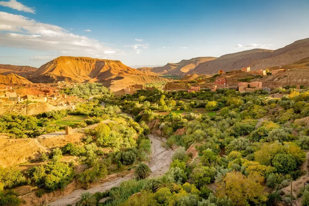 Green oasis valley surrounded by dry mountains in southern Morocco