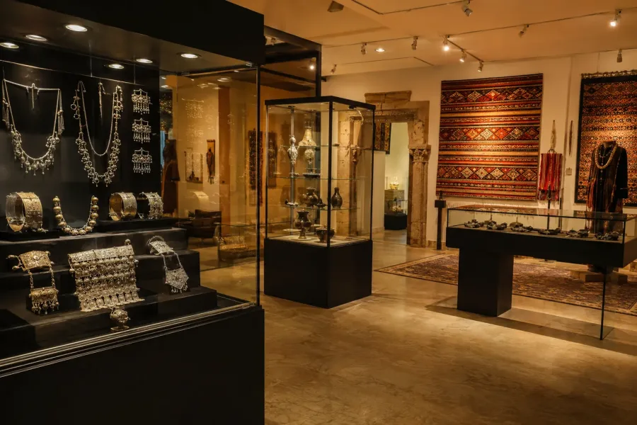 Amazigh silver jewelry and woven textiles displayed in an Agadir museum