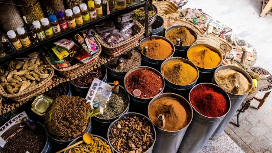 Colorful mounds of spices displayed in a Fes Medina souk