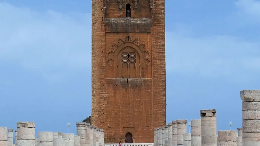 Hassan Tower rising beyond rows of historic stone columns in Rabat