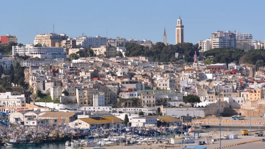 Boats in Tangier harbor beneath the white buildings of the old city